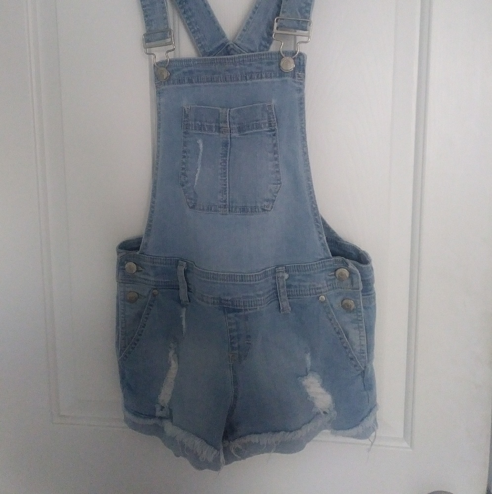 Blue distressed denim overall shorts.
